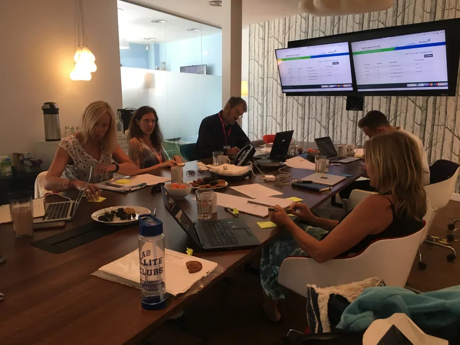 Client and project team members in one of our retrospectives get to work writing their thoughts on sticky notes.